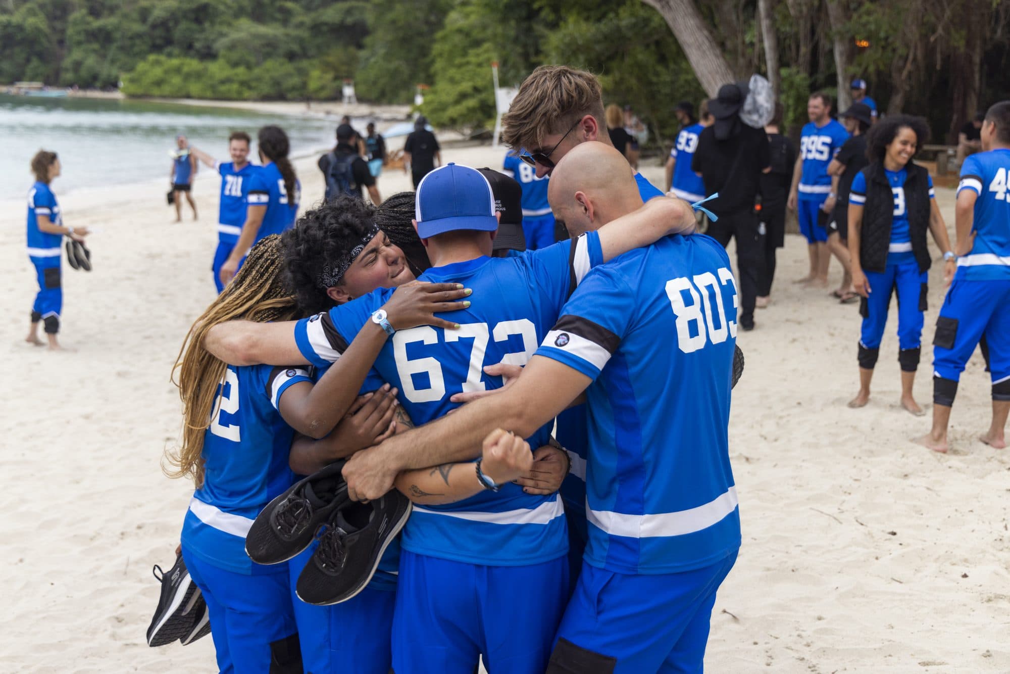 Huddled together in prayer on the island beach