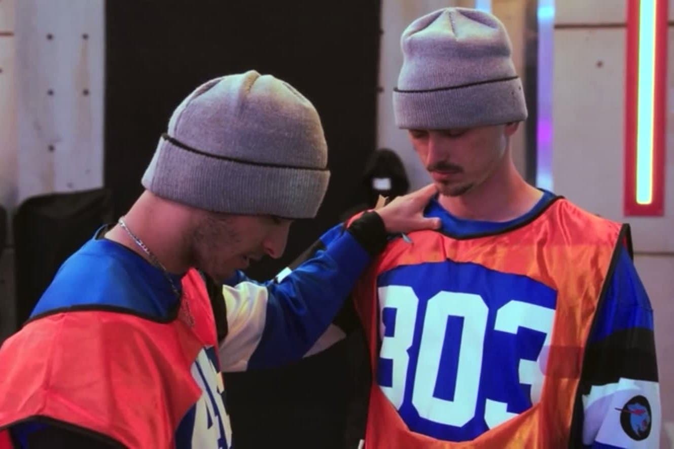 Auzi praying over a fellow contestant before a challenge
