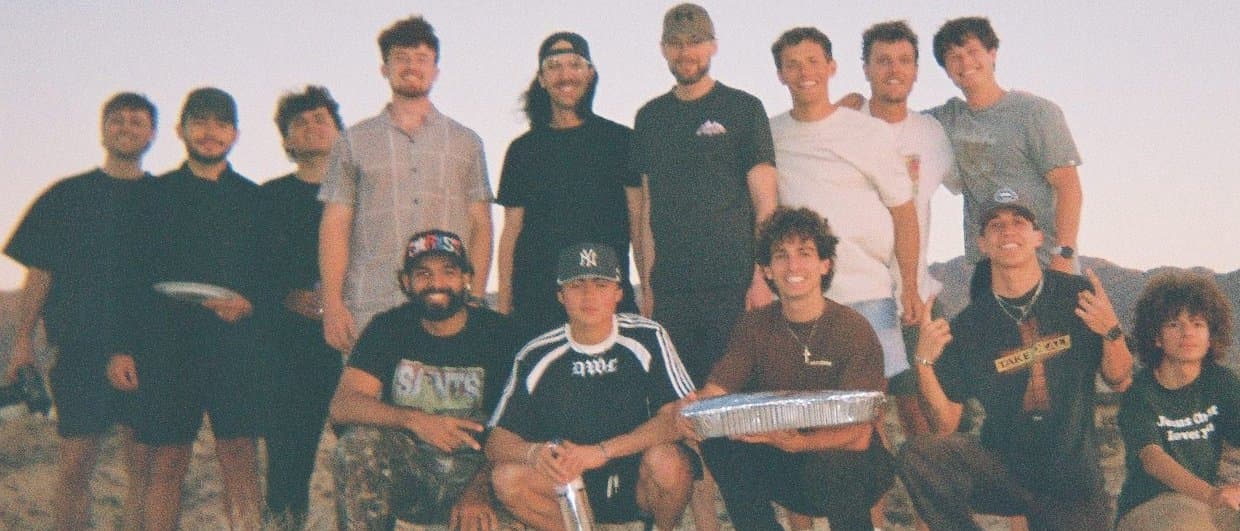 The first Revolutionary Cohort standing together in the desert at dusk