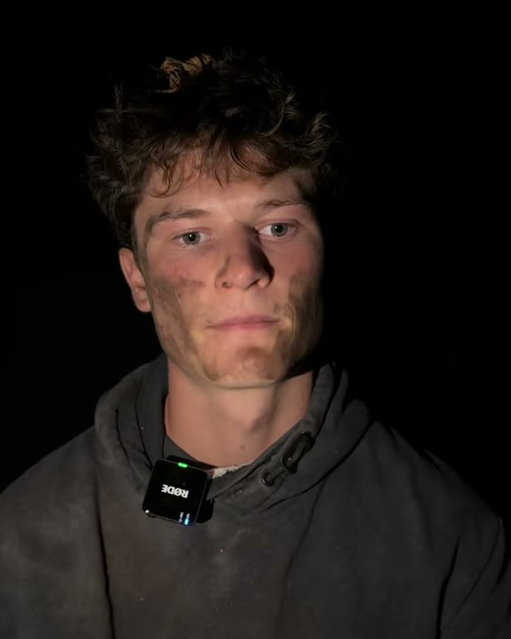 Weston, dirt streaked and lit against the dark, from the Real Treasure video