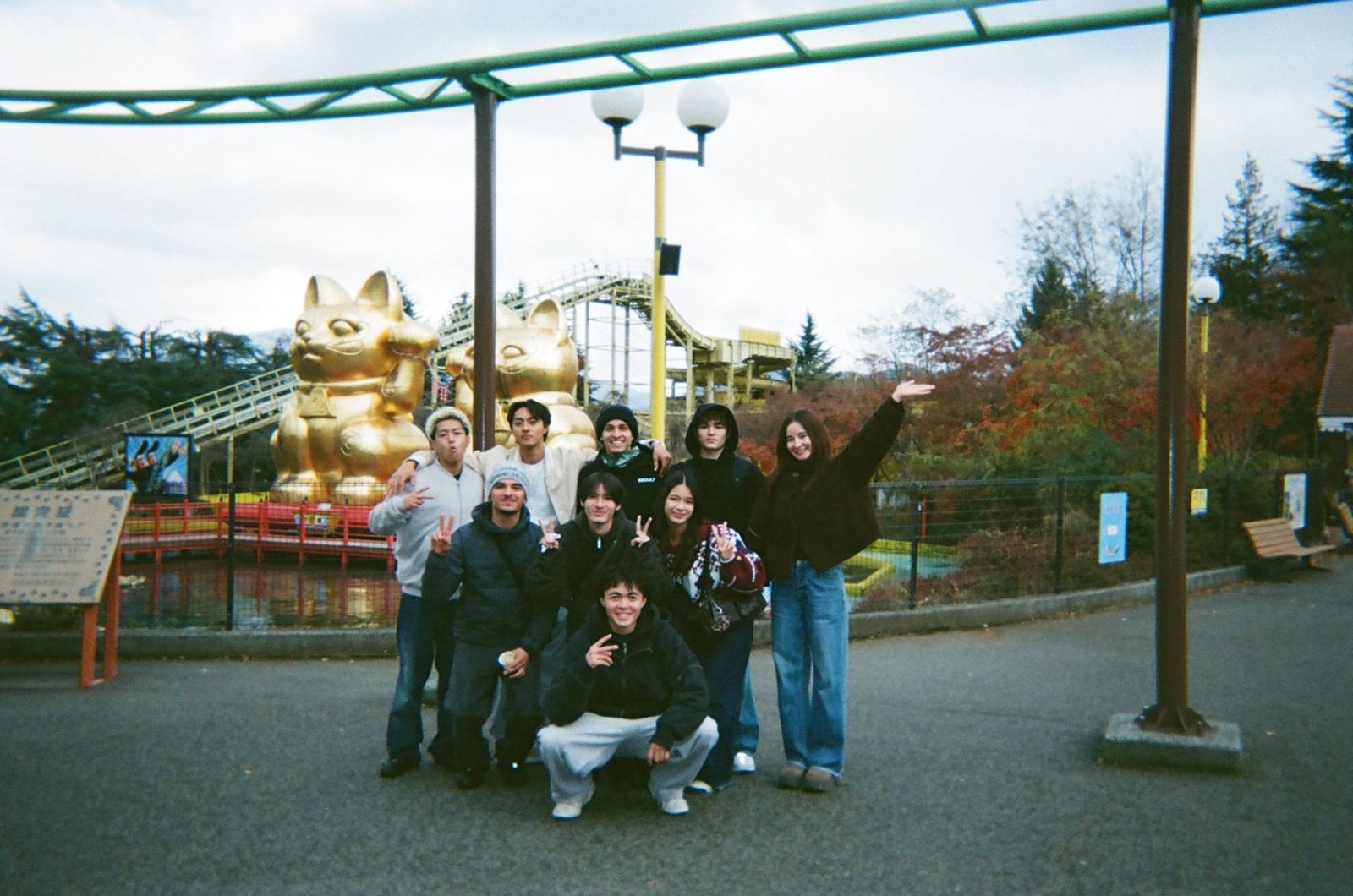The crew gathered under the giant lucky cat